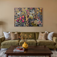 Living room with a green sofa, coffee table, and decorative elements. Original B.Twomey artwork